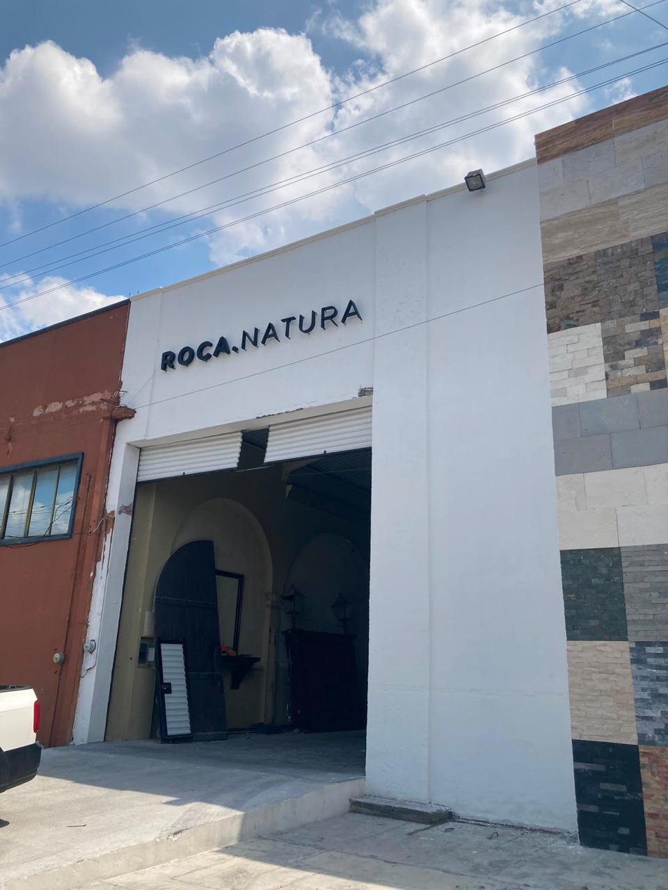 Letrero Roca Natura con halo de luz blanca — vista con luz apagada